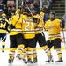 The Michigan Tech team celebrates their fourth goal as a referee separates them from Michigan players at Joe Louis Arena on Saturday, Dec. 29. Daniel Brenner I AnnArbor.com